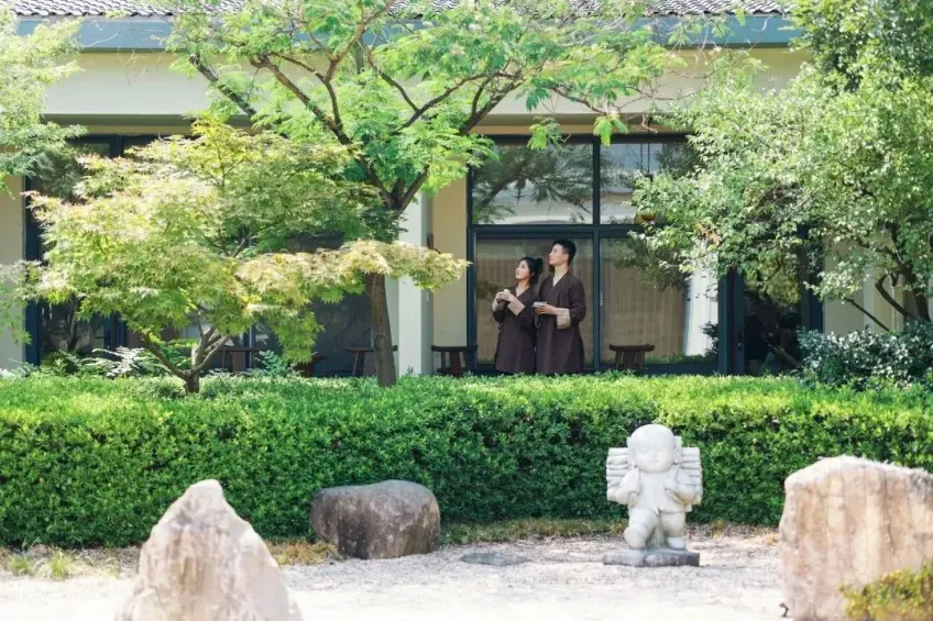 精舍庭院两人持杯站立观景