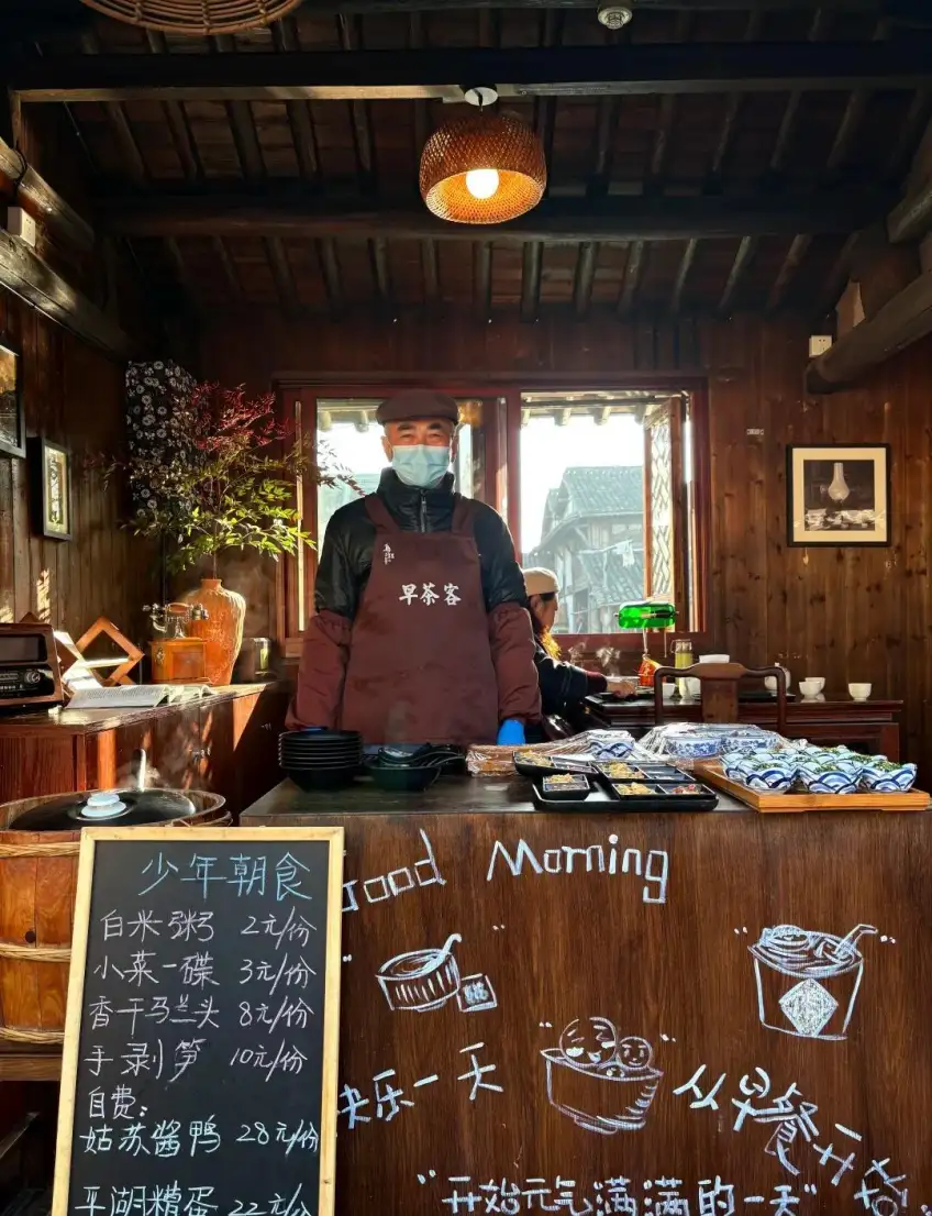 乌镇早茶铺暖色木柜台与店员