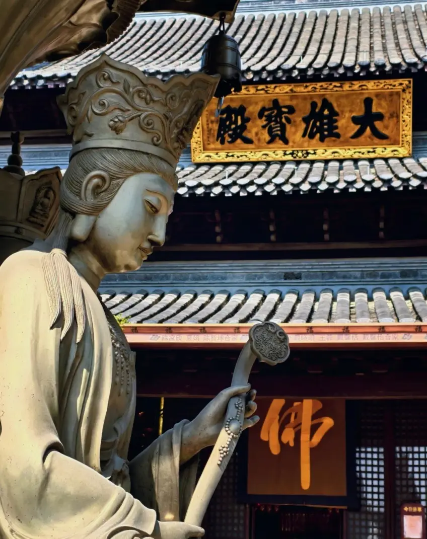 大雄宝殿匾额前石像侧影示意