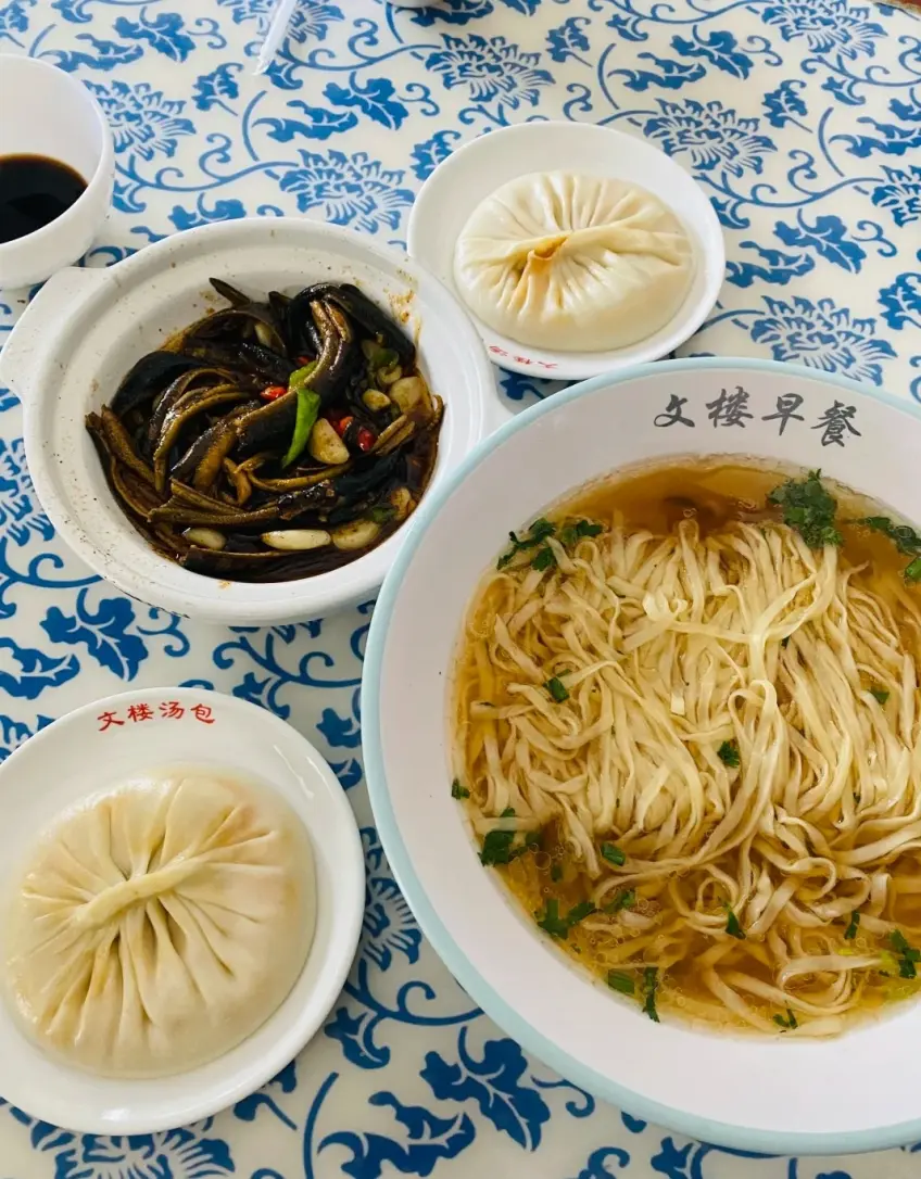 古文樓早餐麵配湯包與長魚拼盤豎構圖示意