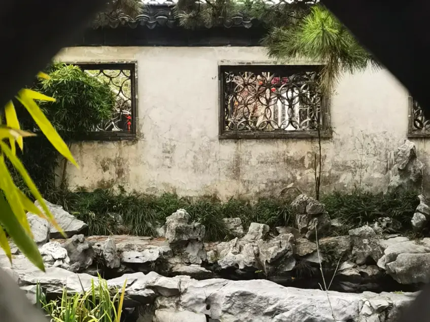 故居月洞門框景假山與漏窗白牆