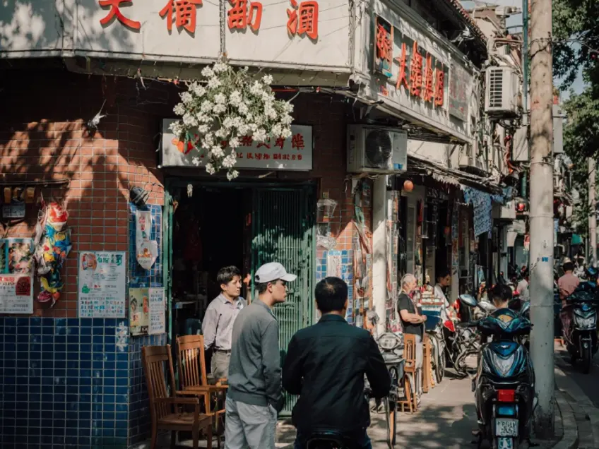 老弄堂街角蓝砖门面与坐椅闲聊