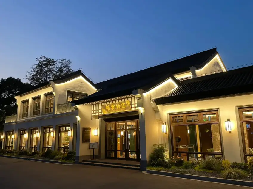 橫雲飯店白牆黑瓦黃昏燈火外立面